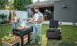 Preview: Paar grillt im Garten mit der Anker SOLIX EverFrost 2 40L Akku-Kühlbox als Getränkestation neben dem Grill